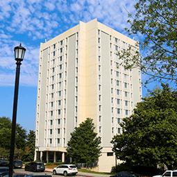 A front corner angle of Bates West with trees in the foreground.