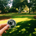 hand holding up globe sticker on horseshoe