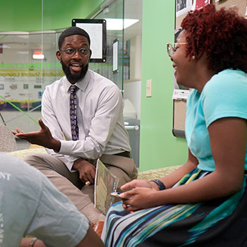 Student talking to other students in a leadership role.