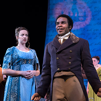 Two actors on stage in full costume in a play of Sense and Sensibility. 