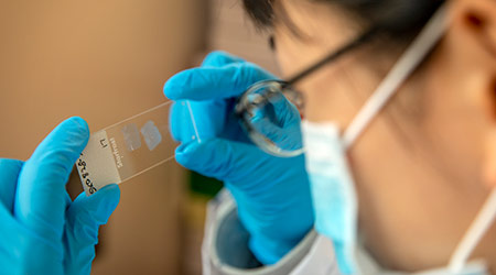 Researcher examining a slide. 