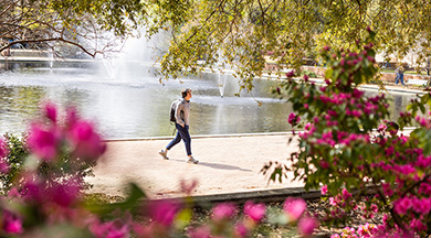 Student walking in front of fountain outside of Thomas Cooper Library