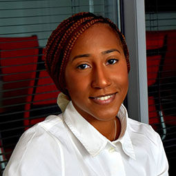 woman smiling with white button up shirt on