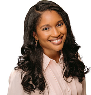 photo of woman smiling with dark hair and pink top on