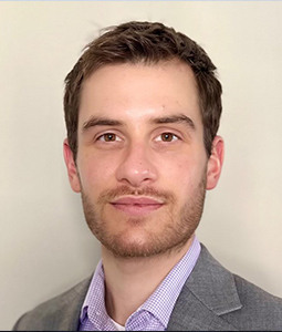 photo of man with gray suit on and dark hair