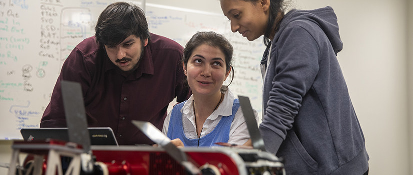 three grad student code a robot together