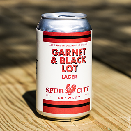 Can of Frat Lot Lager on a wooden table