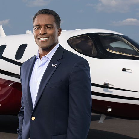 PMBA alumnus Glenn Gonzales in front of one of his Jet It aircrafts