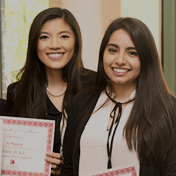 Two students holding certificates