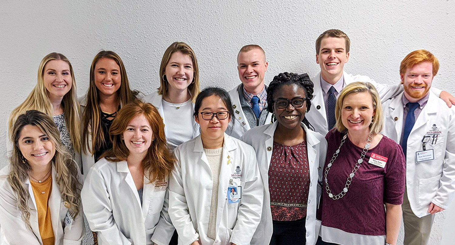 Pharmacy students pose with students from across the health sciences