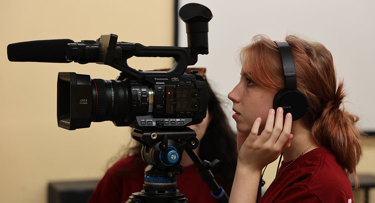 Female student using a camera