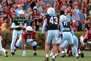 The football team in the middle of a play during the spring game. 