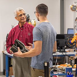 McNAIR director talking with a student