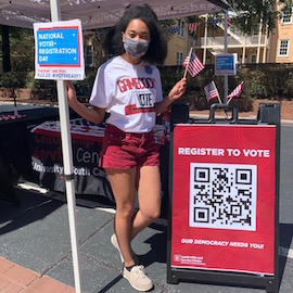 Antonia Adams, a member of CLEAT, on Greene Street for voter registration day. Her shirt says 