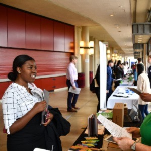 Student speaking to job recruiter at a job fair