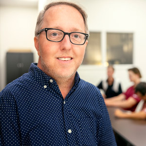 John Grady stands at doorway of USC classroom