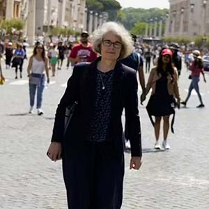 woman stands on a street in italy