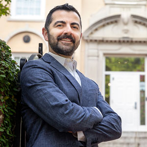 Armen Shaomian crosses his arms and smiles in front of Preston