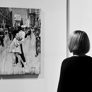 Woman in gallery looking at paintings