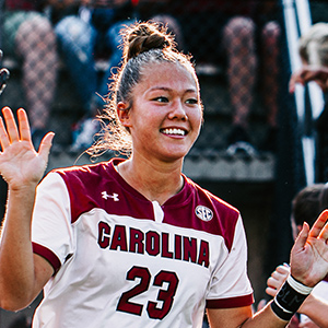 Samantha Chang high-fiving at a soccer game.