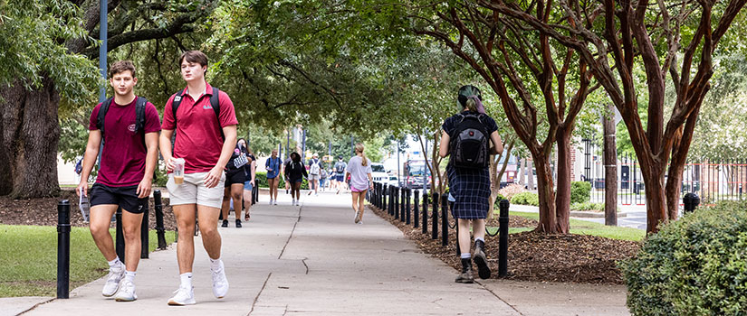 Two male students walk on campus