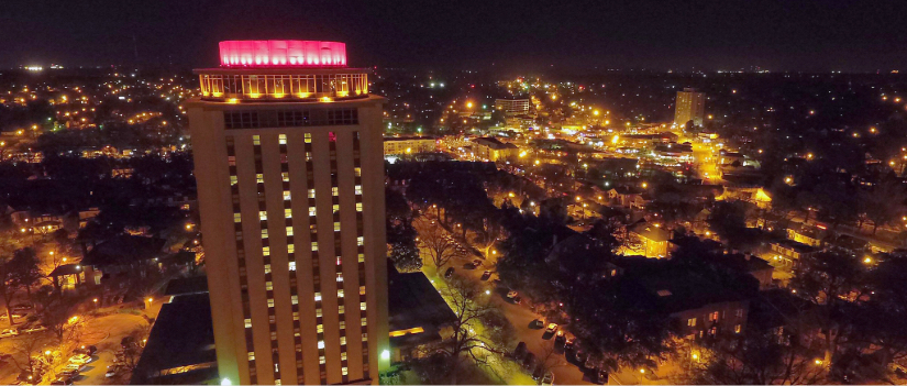 View of the Capstone building lit up at night.