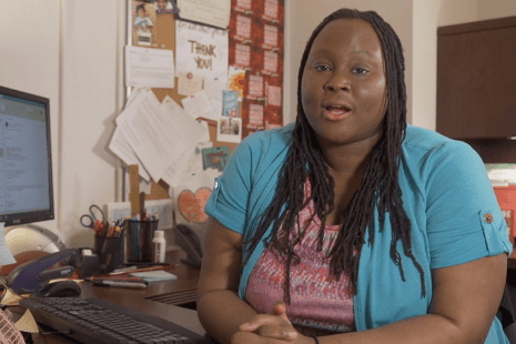 Tecola Jones is in her office being interviewed about greek village housing. 