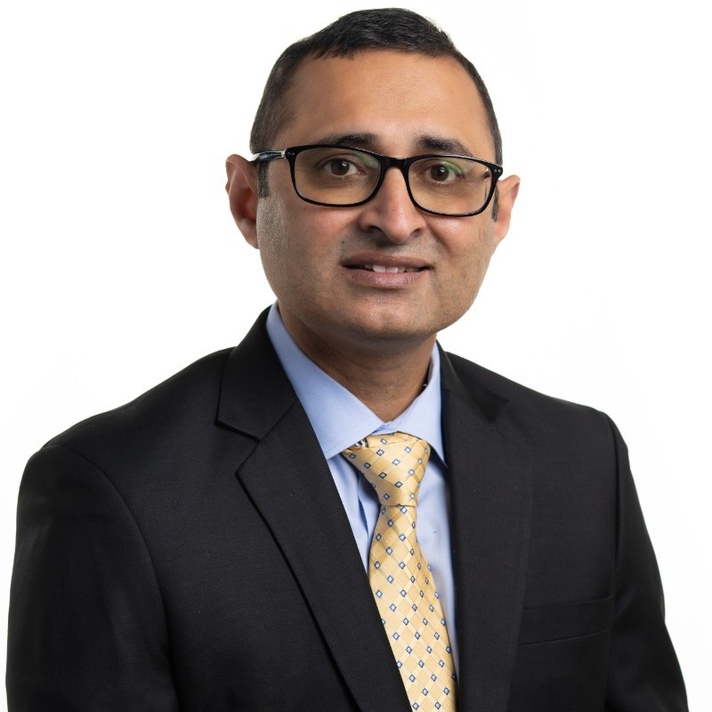 Photo of Dr. Khalid Malik, smiling at the camera