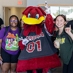 Group photo of people smiling with the University of South Carolina Gamecock mascot.