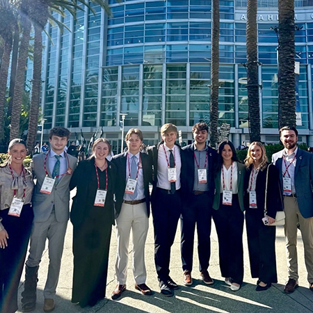 Members of the Club Management Association of America pose at a conference
