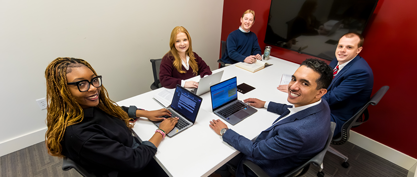 Students meeting in a group study room in the USC Rice School of Law building