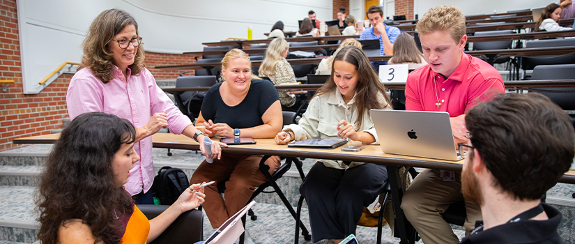 Professor in a classroom with her students