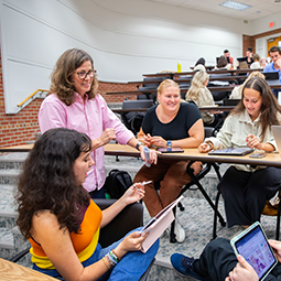 professor with students in a classroom setting