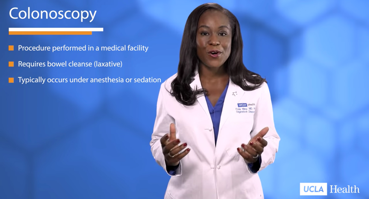 A doctor stands in front of a blue background