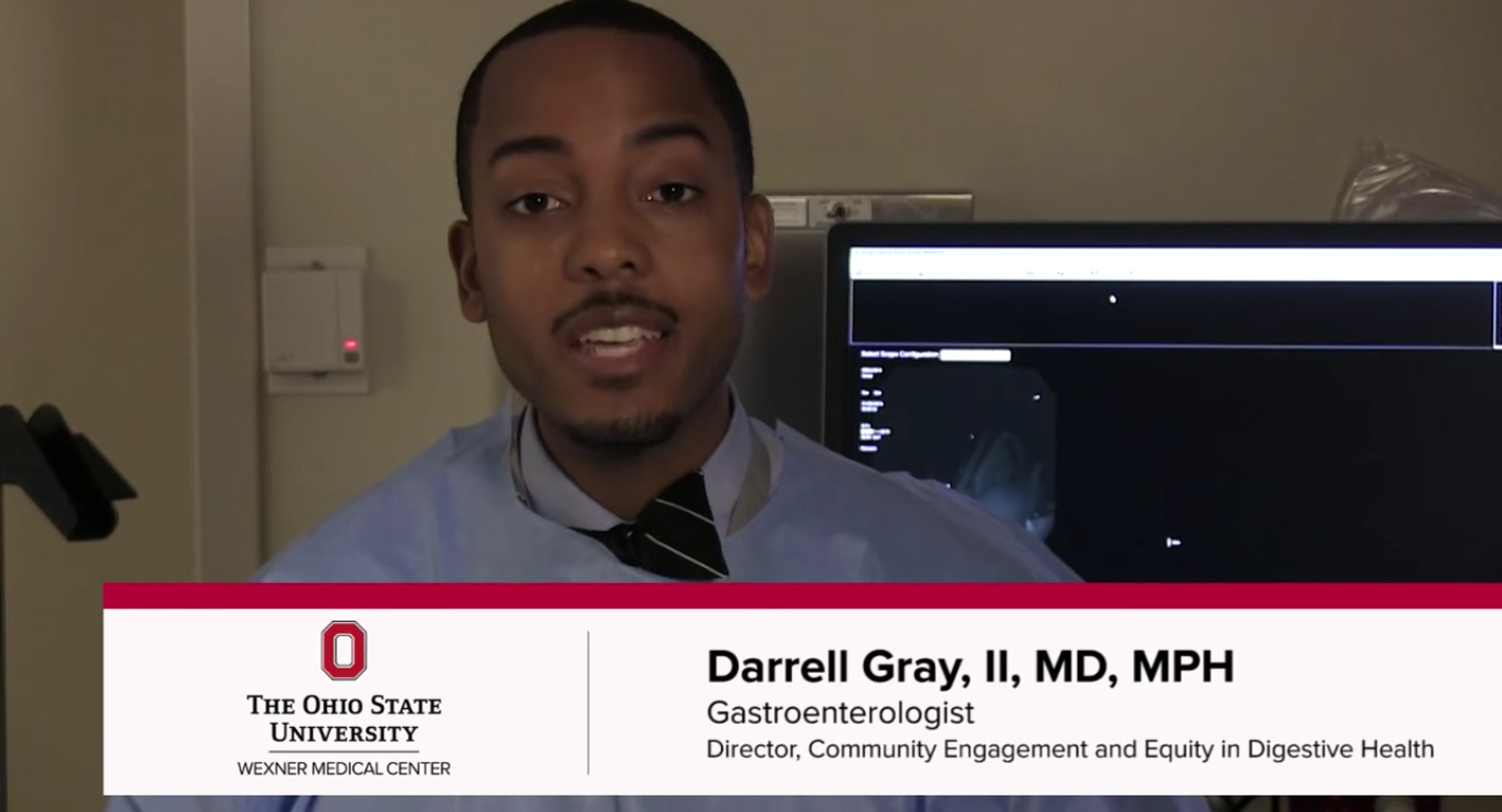 A gastroenterologist sits in front of a computer screen
