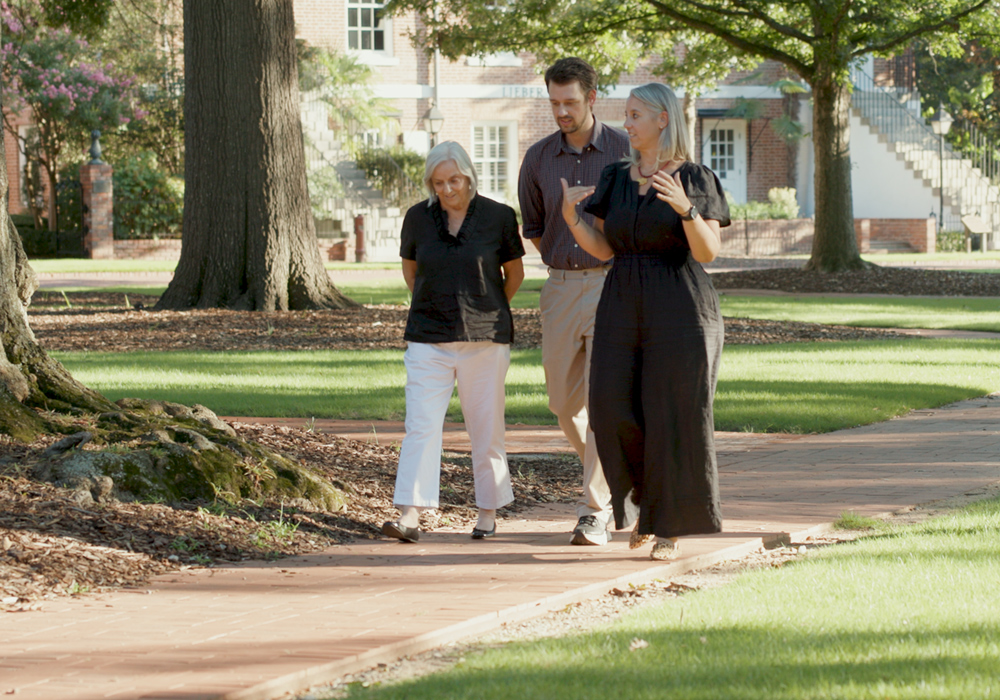 Three generations of one family walk on the Horseshoe as they have a conversation. 
