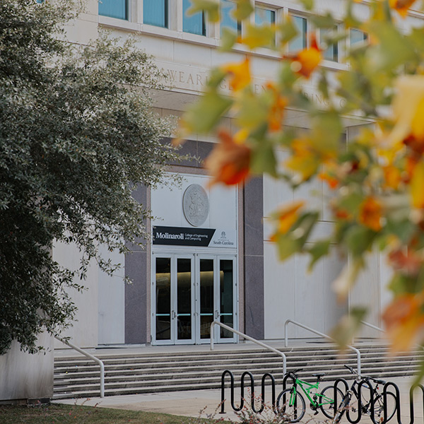 Exterior of USC's Swearingen Engineering building with fall foliage in the foreground