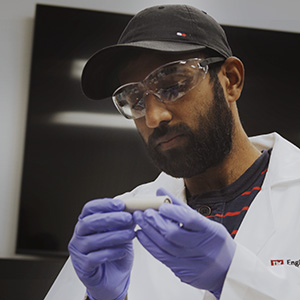 Scientist examines cylindrical battery