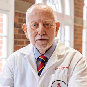 Jim Augustine smiles for the camera at the USC Medical School building.