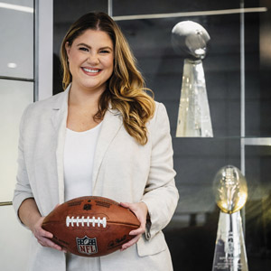 Lauren Greenfield smiles for the camera with a football.