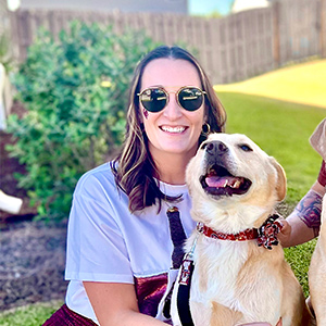 Mary Melissa Roland poses with her husband and three dogs.