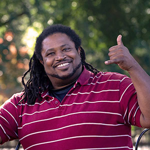 Jonathan Hampton holding the Women's Basketball NCAA Championship trophy.