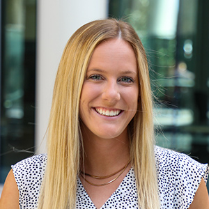 Rebecca Grant smiles standing outside the Moore School of Business.