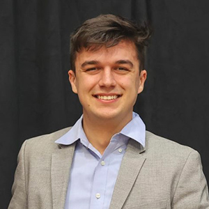 Seth Hajzus holds the Greek Man of the Year award.