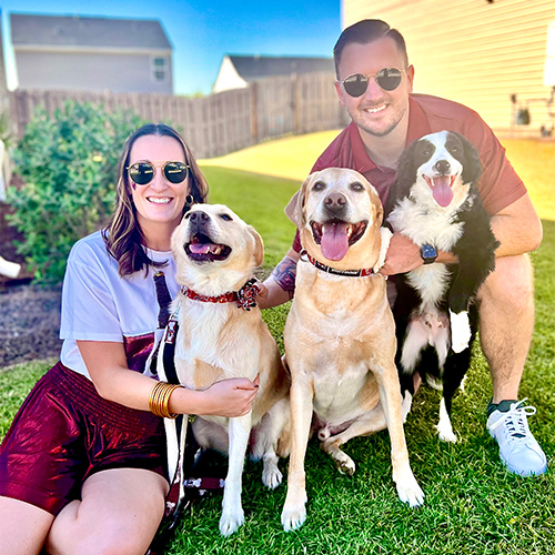 Mary Melissa Roland with her husband and three dogs